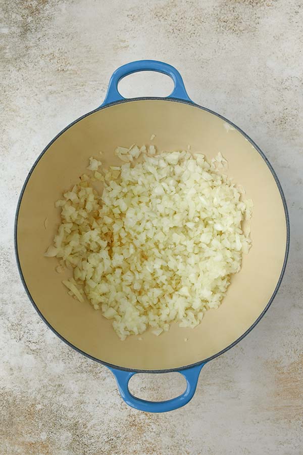 Step one is sauteeing onions in a pot.