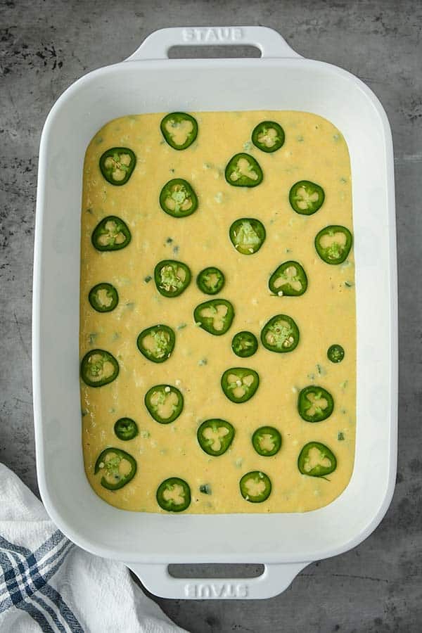 Step five is pouring the batter into a greased baking dish and topping with sliced jalapeños if you like. Then bake.