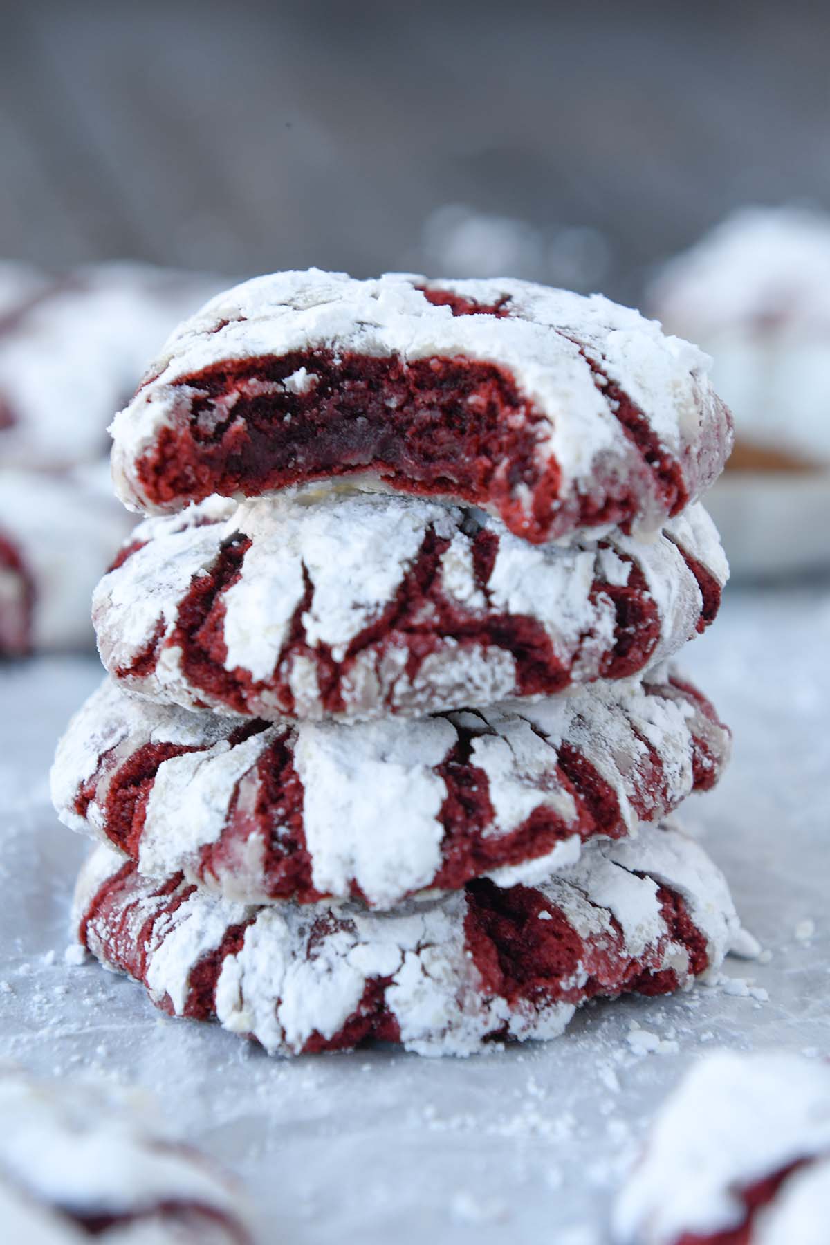 Up close of a stack of red velvet cookies with some in the background.