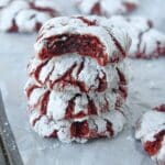 Up close of a stack of red velvet cookies with some in the background.