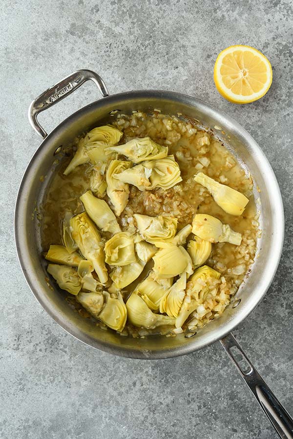 Step five is adding in the chicken broth and a squeeze of lemon.