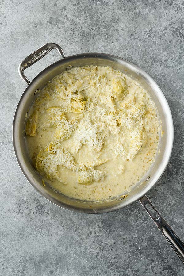 Step seven is sprinkling on the shredded parmesan cheese.