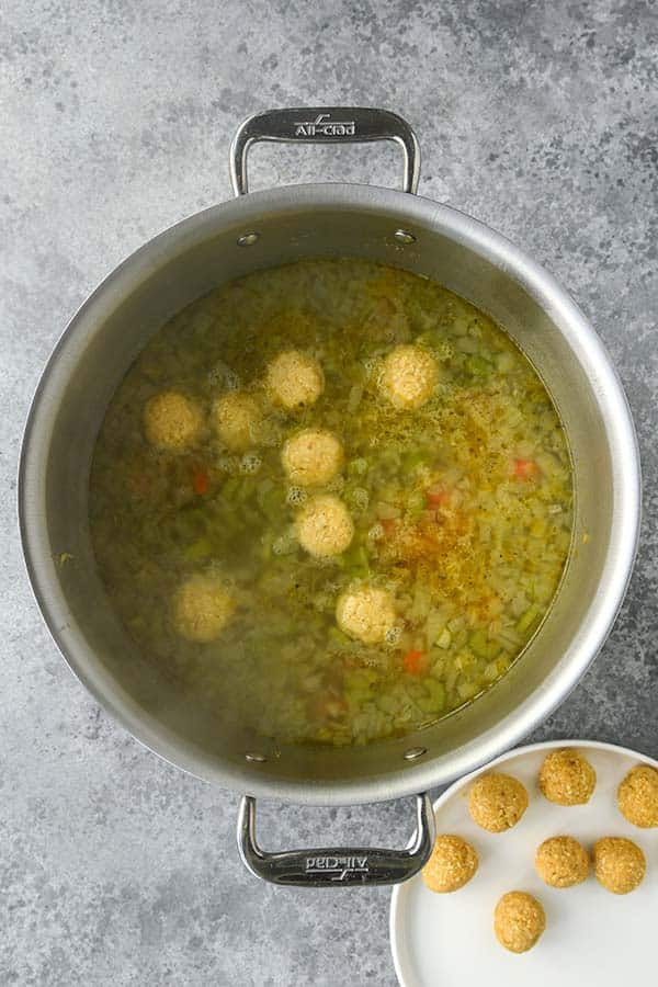 Step six is dropping the matzo balls into the hot soup.