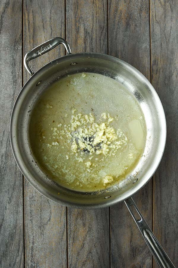 Step four is starting the sauce by melting butter and adding the garlic.
