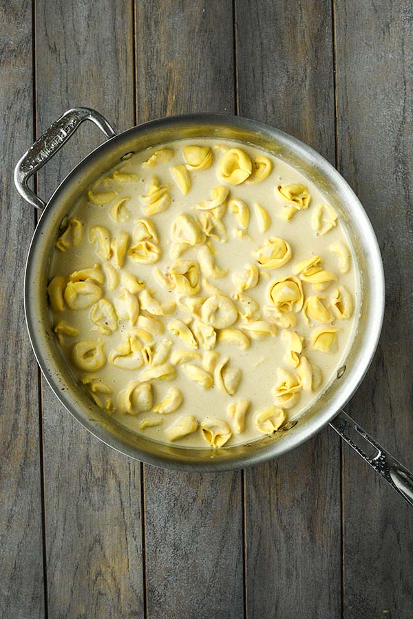 Step five is adding in the heavy cream and the tortellini.