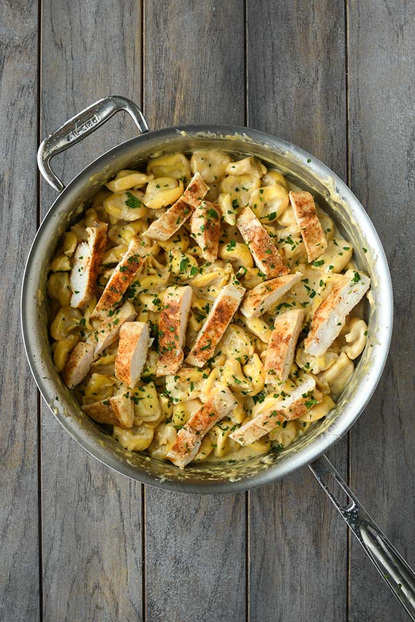 Step six is cutting up the cooked chicken and mix it in with the tortellini.