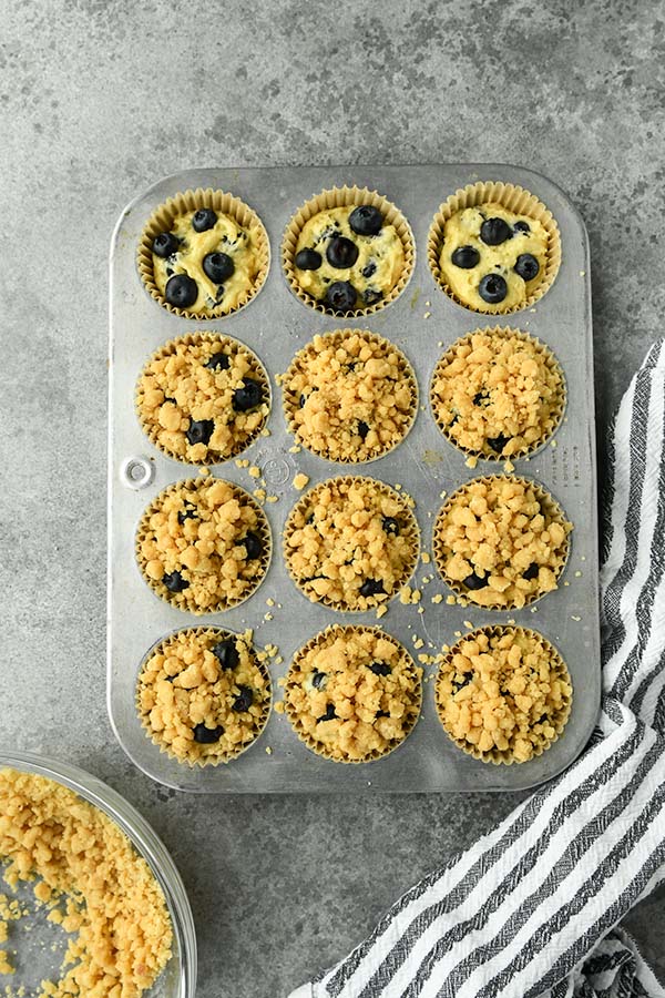 Step six is filling the muffin cups and topping each one with the crumble.
