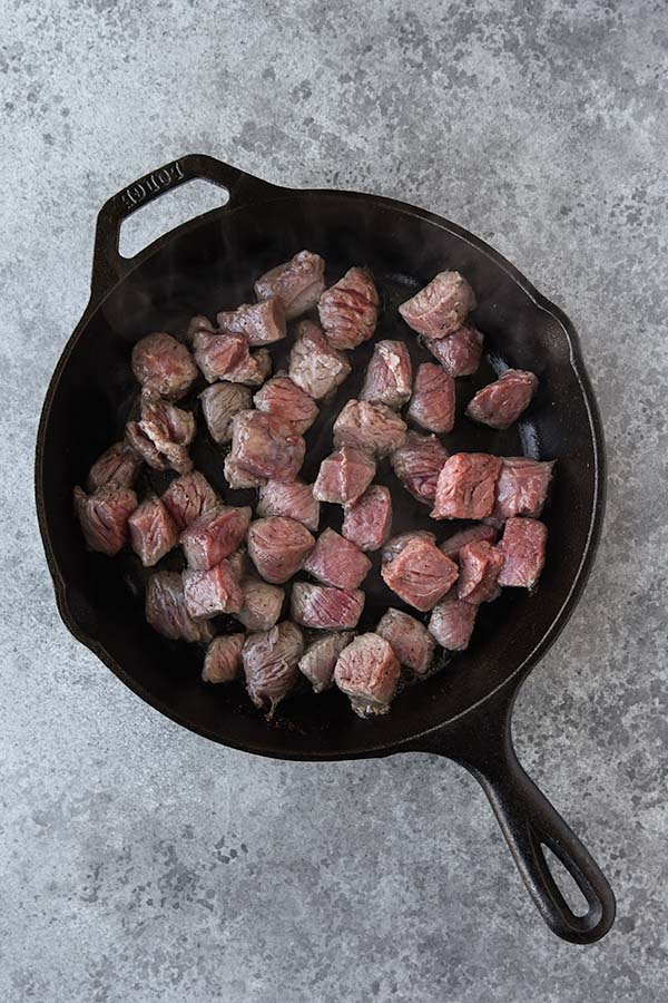 Step two is adding the steak into the pan with the hot oil.