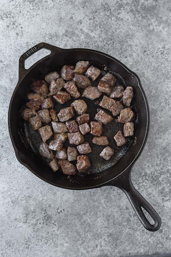 Step three is to flip over the steak pieces. 