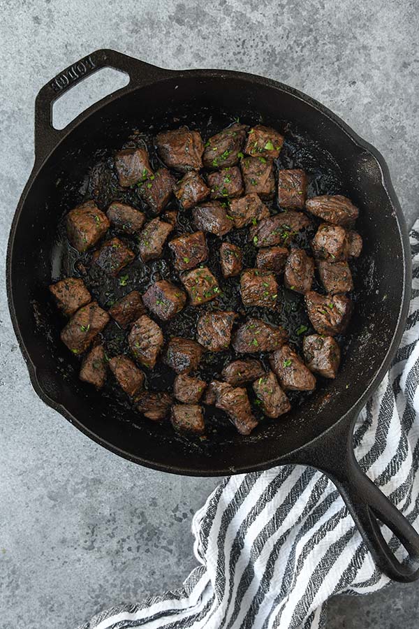 Step six is to add the steak back in to the rosemary garlic butter.