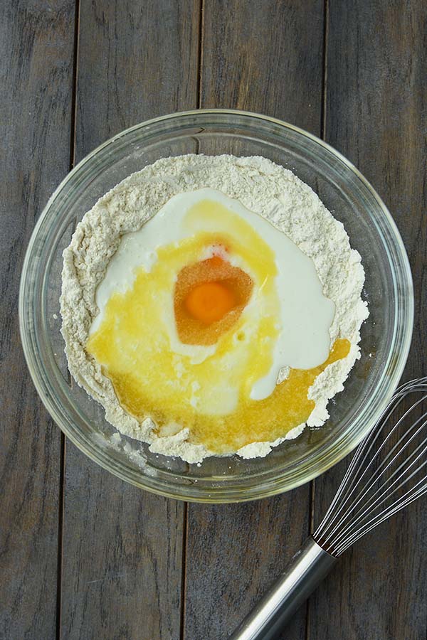 Step two is a glass bowl with the wet ingredients added into a well in the center of the dry ingredients.
