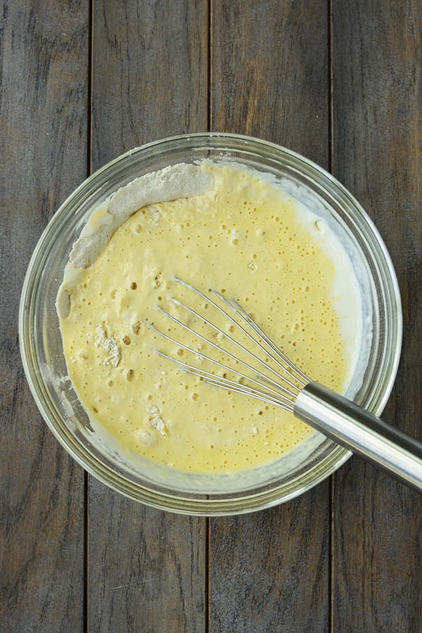 Step three is a glass bowl with the ingredients being whisked together.