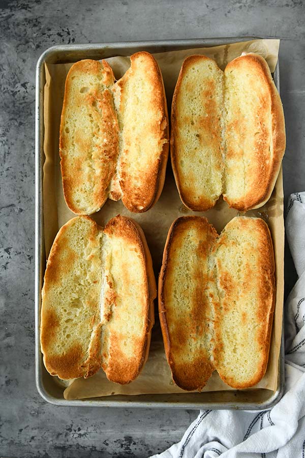 Step three is four toasted rolls on a baking sheet.