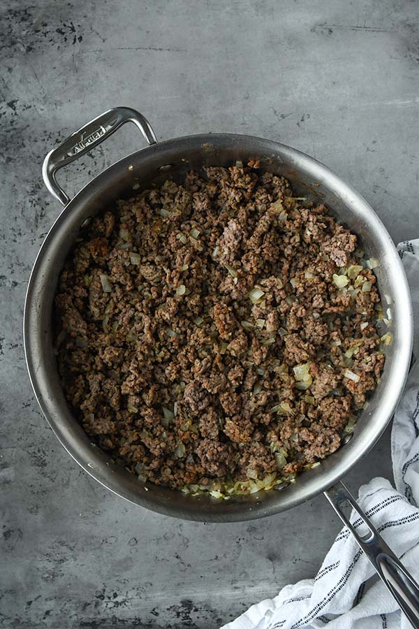 Step four is the cooked ground beef mixed with onions and garlic and drained of grease.
