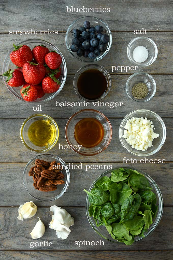 All of the ingredients needed to make strawberry spinach salad.
