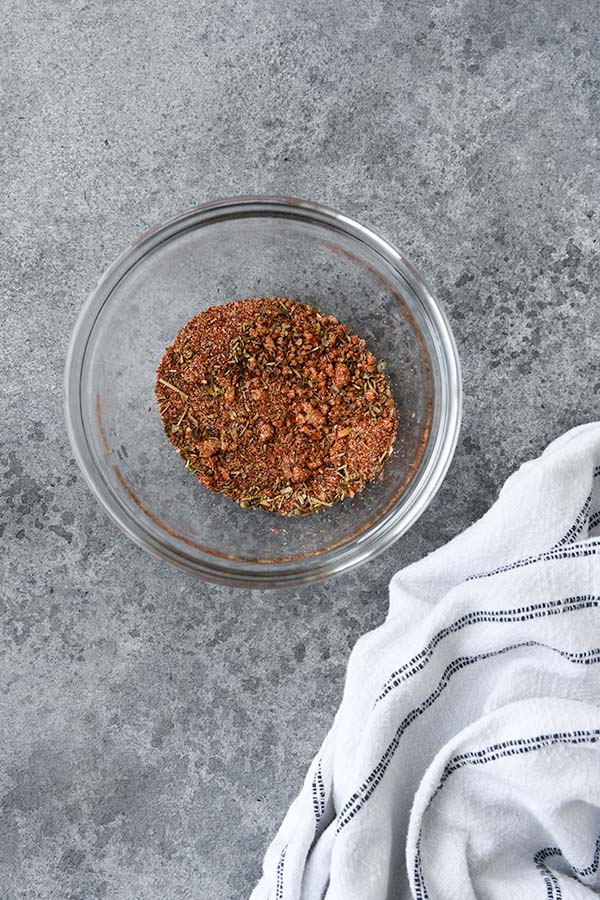 Step one is a small glass bowl with all of the seasonings mixed together.