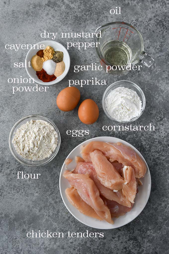 All of the ingredients needed to make chicken tenders on the stove.