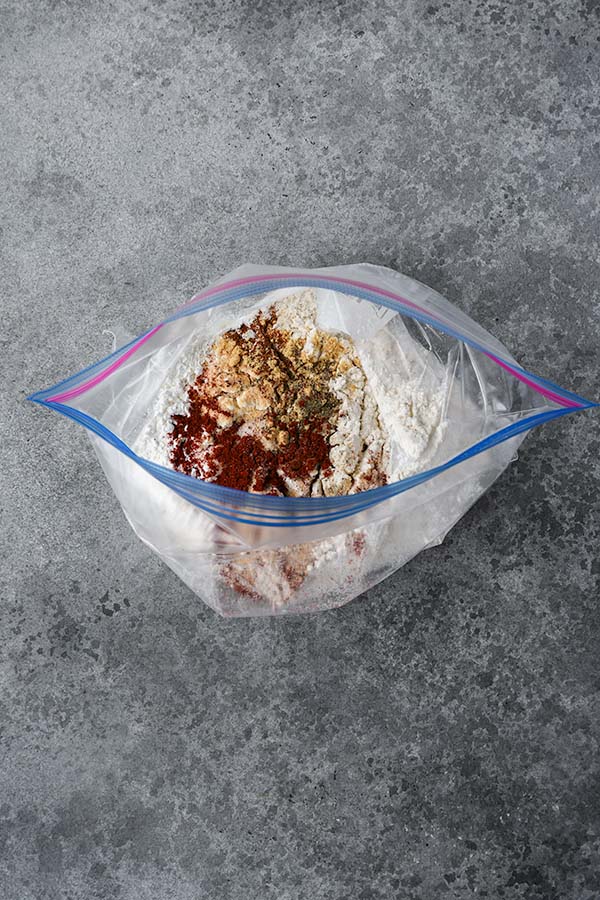Step one is all of the seasonings and flour added to a gallon zip bag.