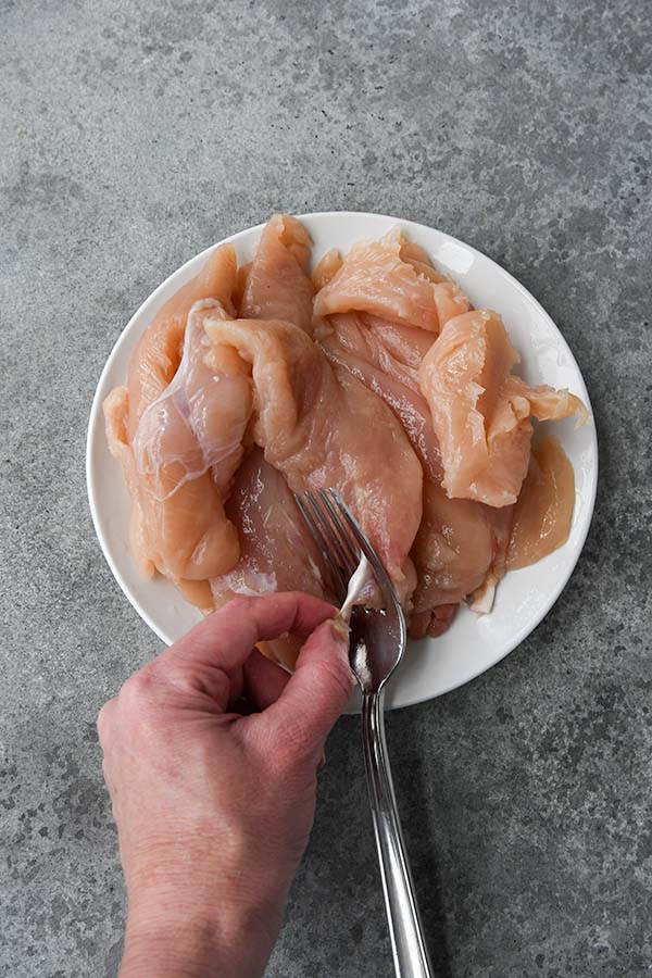 Step three is a plate of chicken tenders with a fork removing the tendon from each one.