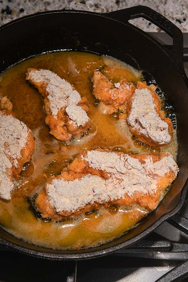 Step seven is a few tenders being cooked in the pan of hot oil.