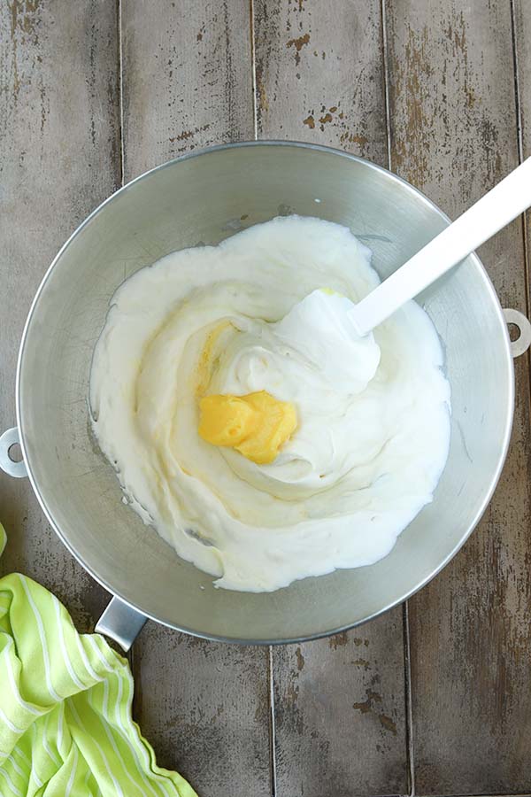 Step six is gently mixing the pudding into the whipped cream.