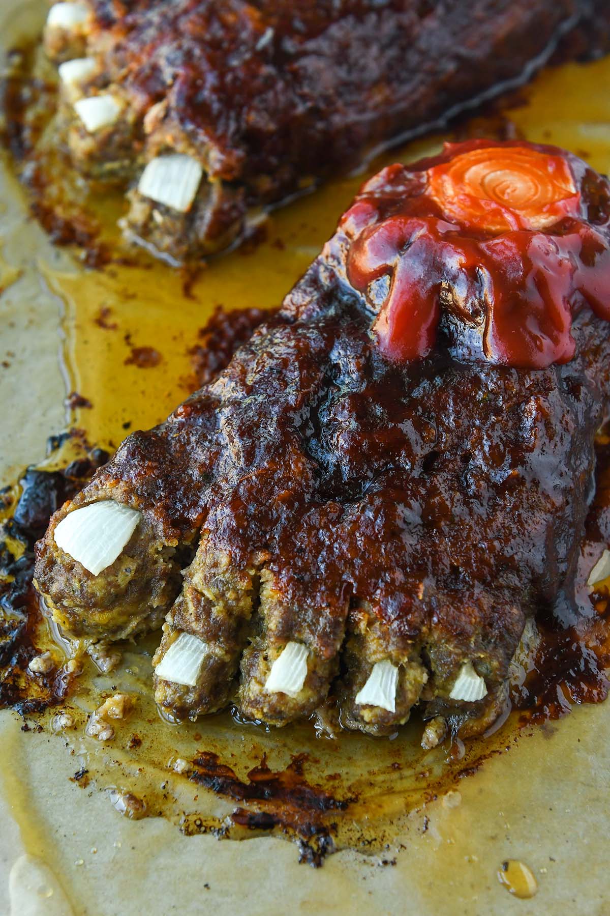 Up close of baked Halloween feetloaf on a baking tray.