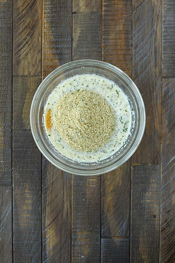 Step one is eggs, milk, and breadcrumbs to a large glass bowl.