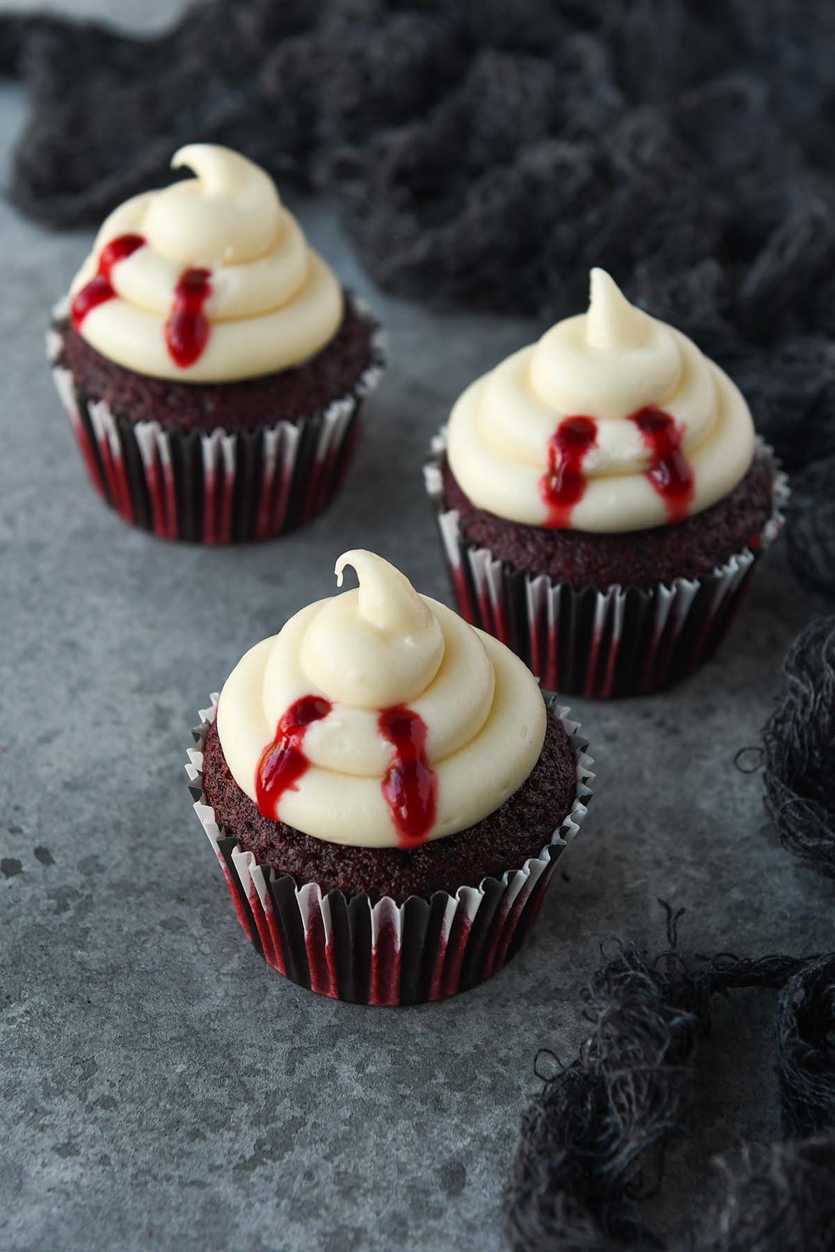 Three vampire bitten cupcakes