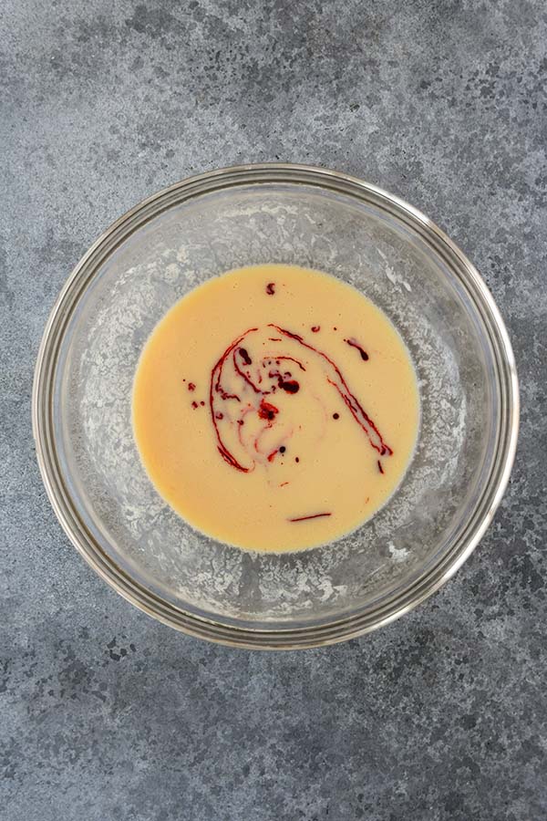 Step three is the red food dye added to the wet ingredients.