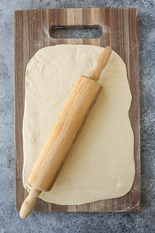 Step one is rolling out the pizza dough.