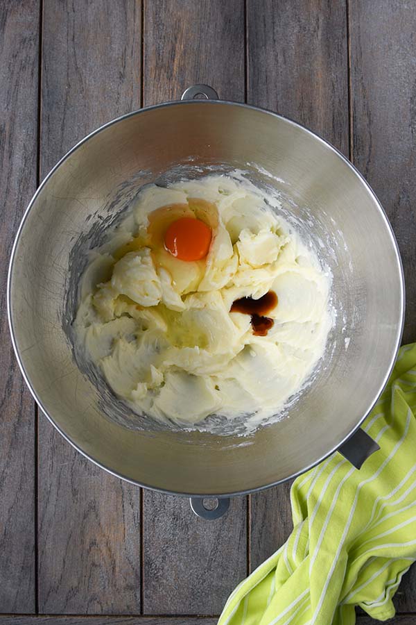Step three is mixing in the egg, extracts, and food coloring.